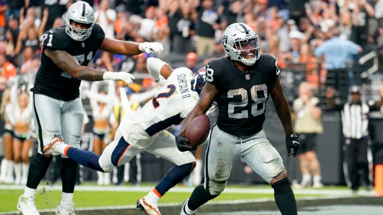 Las Vegas Raiders running back Josh Jacobs (28) scores a touchdown against the Denver Broncos during the second half of an NFL football game. (Abbie Parr/AP)