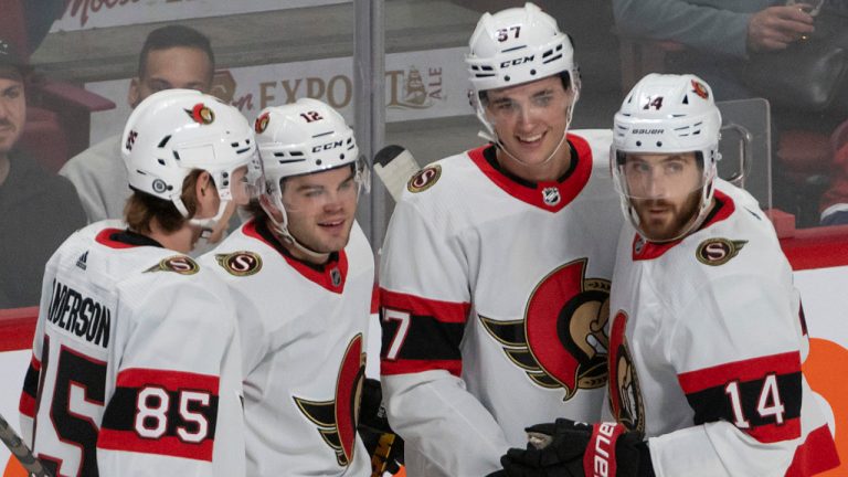 Ottawa Senators Alex DeBrincat, second from left, is all smiles celebrating with teammates Jake Sanderson (85), Shane Pinto (57) and Tyler Motte (14) after scoring against the Montreal Canadiens the during first period NHL hockey action in Montreal, Tuesday, Oct. 4, 2022. (Peter McCabe/CP)