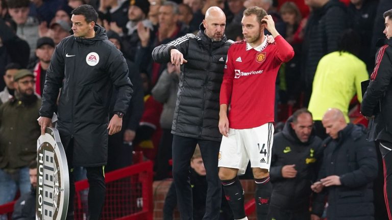 Manchester United's Christian Eriksen talks with head coach Erik ten Hag as he prepares to come onto the field during the English Premier League soccer match between Manchester United and Tottenham Hotspur at Old Trafford in Manchester, England, Wednesday, Oct. 19, 2022. (Dave Thompson/AP)