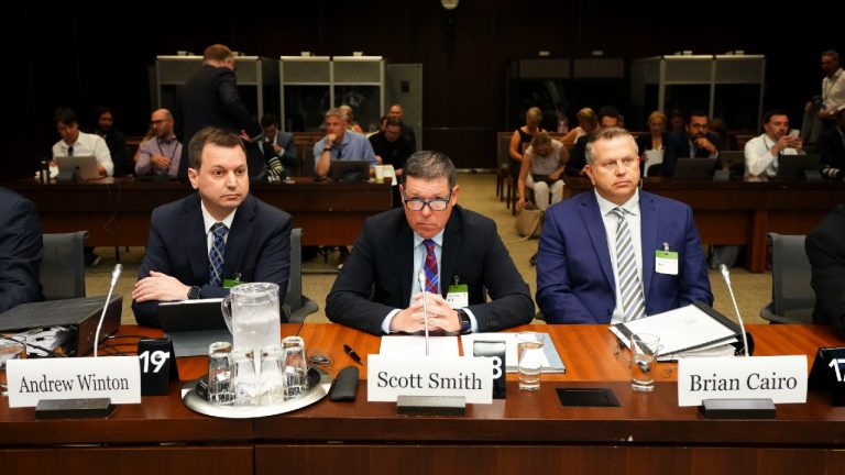 Lawyer Andrew Winton sits alongside witnesses Scott Smith, Hockey Canada President and Chief Operating Officer and Hockey Canada Chief Financial Officer Brian Cairo, as they appear at the standing committee on Canadian Heritage in Ottawa on Wednesday, July 27, 2022, looking into how Hockey Canada handled allegations of sexual assault and a subsequent lawsuit. (Sean Kilpatrick/CP)