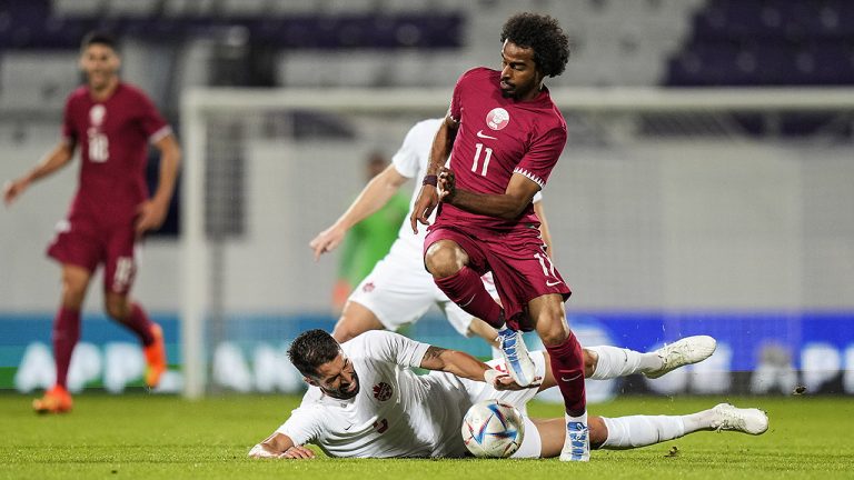 Qatar's Akram Afif runs with the ball as Canada's Steven Vitoria tries to stop him during an international friendly ahead of the 2022 World Cup. (Florian Schroetter/AP)