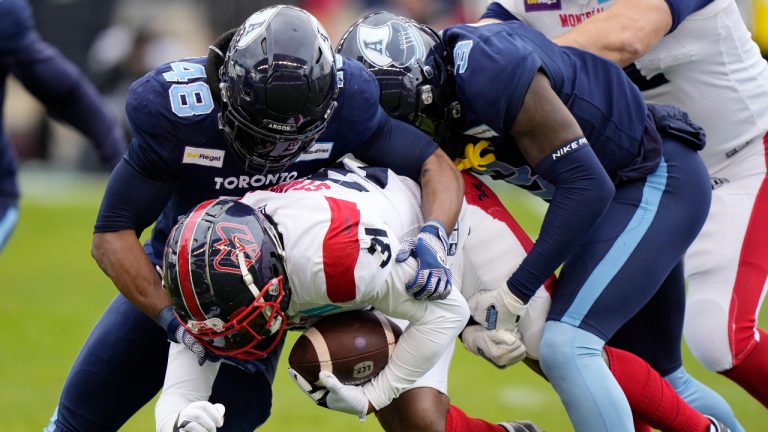 Montreal Alouettes running back William Stanback (31) is tackled by Toronto Argonauts linebacker Wynton McManis (48) and defensive back Jamal Peters (3) during first half CFL Eastern Final football action in Toronto on Sunday, November 13, 2022. (Frank Gunn/CP)