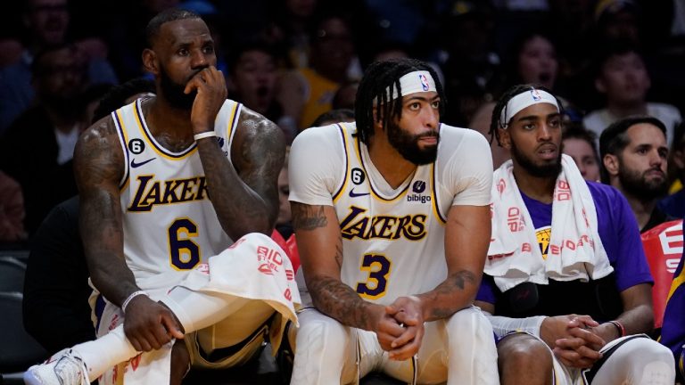 From left to right, Los Angeles Lakers forward LeBron James, forward Anthony Davis and forward Troy Brown Jr. sit on the bench in the closing minutes of a loss to the Cleveland Cavaliers. (Marcio Jose Sanchez/AP)