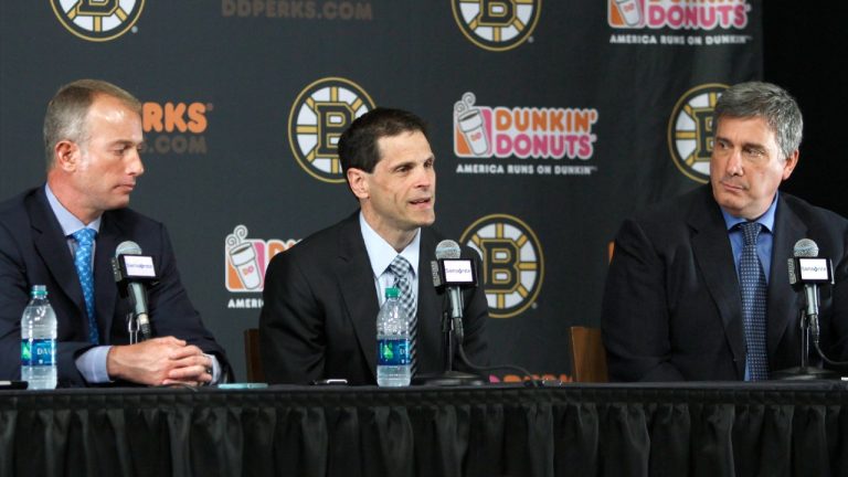 The Boston Bruins management group includes general manager Don Sweeney, centre, CEO Charlie Jacobs, left, and president Cam Neely, right. (Bill Sikes/AP)