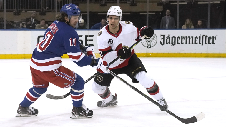 New York Rangers left wing Artemi Panarin is defended by Ottawa Senators' Artem Zub during the third period of an NHL hockey game Saturday, April 9, 2022, in New York. (AP)