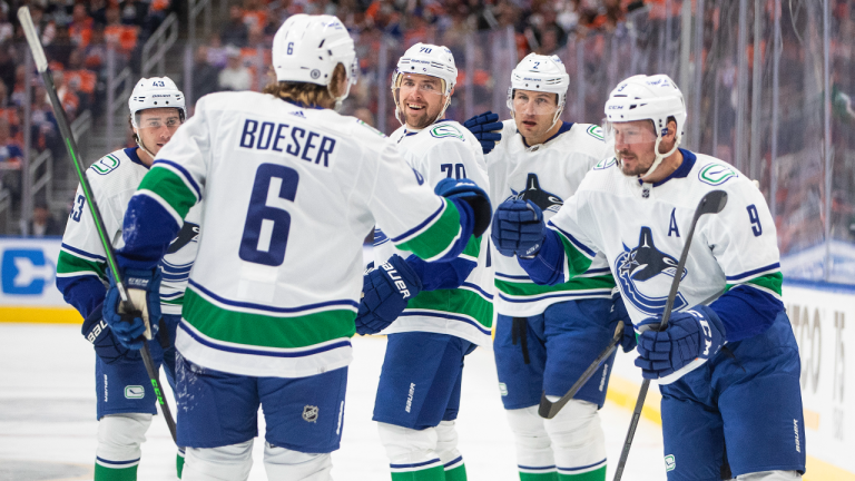 Vancouver Canucks' J.T. Miller (9) celebrates his goal against the Edmonton Oilers with teammates Quinn Hughes, left to right, Brock Boeser, Tanner Pearson and Luke Schenn during first period NHL action in Edmonton on Wednesday, October 12, 2022. (CP)