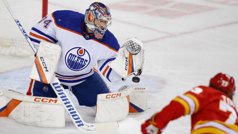 Edmonton Oilers goalie Stuart Skinner makes a save against Calgary Flames' Tyler Toffoli during first period NHL hockey action in Calgary, Saturday, Oct. 29, 2022. (CP)