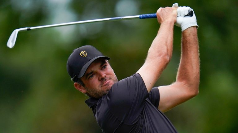 Corey Conners, of Canada, hits from the sixth tee during their singles match at the Presidents Cup golf tournament at the Quail Hollow Club, Sunday, Sept. 25, 2022, in Charlotte, N.C. (AP Photo/Julio Cortez)