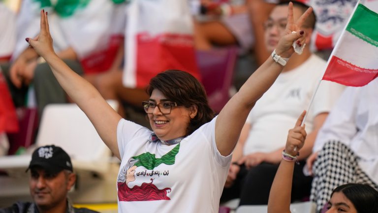 Iranian soccer fans cheer prior to the World Cup group B soccer match between England and Iran at the Khalifa International Stadium in in Doha, Qatar, Monday, Nov. 21, 2022. (AP Photo/Alessandra Tarantino)