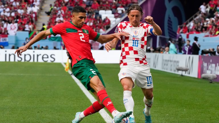 Croatia's Luka Modric (10) and Morocco's Achraf Hakimi (2) compete for the ball during the World Cup group F soccer match between Morocco and Croatia, at the Al Bayt Stadium in Al Khor, Qatar. (Themba Hadebe/AP)