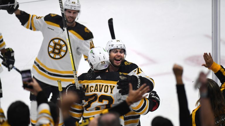 Boston Bruins' Jake DeBrusk (74) celebrates Charlie McAvoy's goal against the Florida Panthers' during the first period of an NHL hockey game, Wednesday, Nov. 23, 2022, in Sunrise, Fla. (AP Photo/Michael Laughlin)