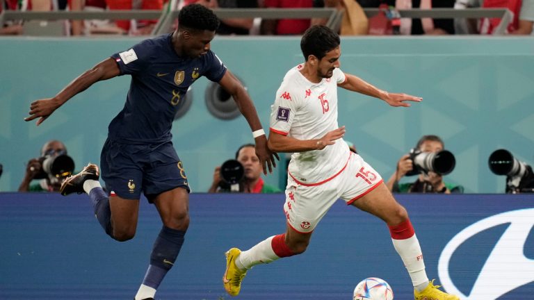 France's Aurelien Tchouameni, left, chases Tunisia's Mohamed Ali Ben Romdhane during the World Cup group D soccer match between Tunisia and France at the Education City Stadium in Al Rayyan , Qatar, Wednesday, Nov. 30, 2022. (AP Photo/Christophe Ena)