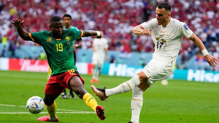 Cameroon's Collins Fai, left, and Serbia's Filip Kostic battle for the ball during the World Cup group G soccer match between Cameroon and Serbia, at the Al Janoub Stadium in Al Wakrah, Qatar, Monday, Nov. 28, 2022. (Manu Fernandez/AP)