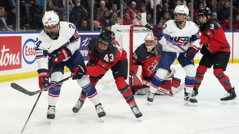 United States' Gabby Rosenthal (24) protects the puck from Canada's Kristin O’Neill (43) during first period Rivalry Series hockey action in Kelowna, B.C., Tuesday, Nov. 15, 2022. (Jesse Johnston/CP)