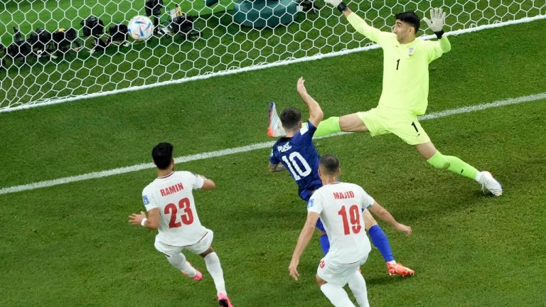 Christian Pulisic of the United States, center, scores the opening goal during the World Cup group B soccer match between Iran and the United States at the Al Thumama Stadium in Doha, Qatar, Tuesday, Nov. 29, 2022. (Hassan Ammar/AP)