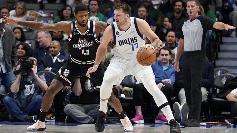 Dallas Mavericks guard Luka Doncic (77) dribbles against Los Angeles Clippers guard Paul George (13) during the first quarter of an NBA basketball game in Dallas, Tuesday, Nov. 15, 2022. (LM Otero/AP)