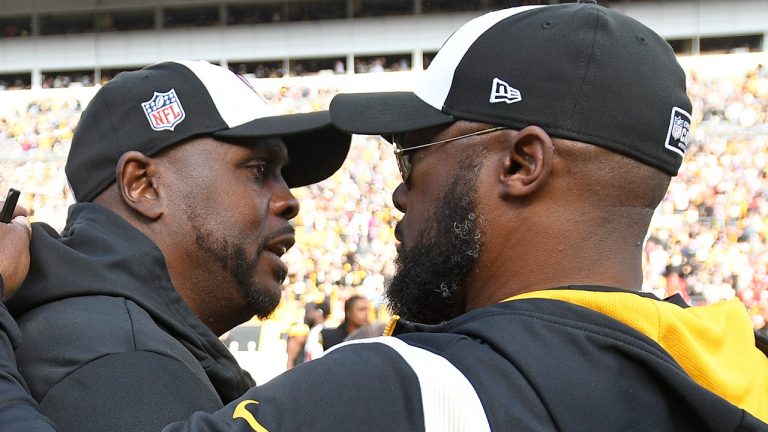 Pittsburgh Steelers head coach Mike Tomlin, right, talks with Tampa Bay Buccaneers head coach Todd Bowles following an NFL football game in Pittsburgh, Sunday, Oct. 16, 2022. (Don Wright/AP)