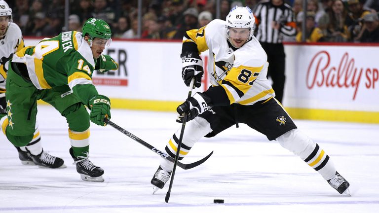 Pittsburgh Penguins centre Sidney Crosby  controls the puck in front of Minnesota Wild centre Joel Eriksson Ek during the second period of an NHL hockey game Thursday, Nov. 17, 2022, in St. Paul, Minn. (Andy Clayton-King/AP)