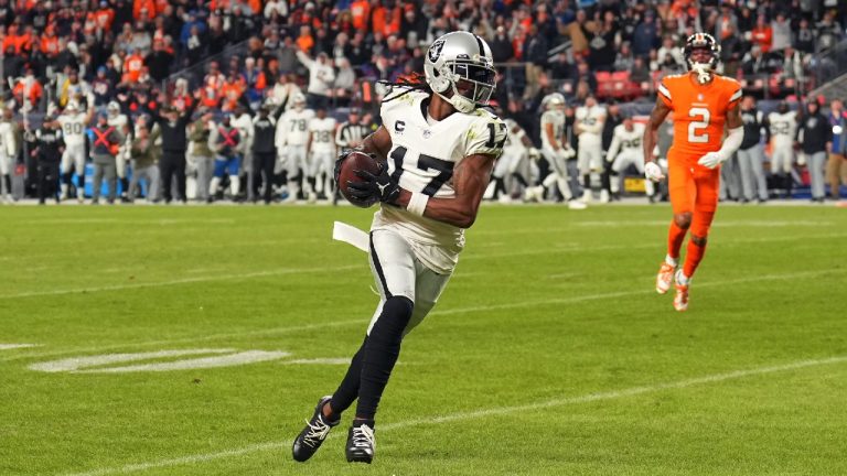 Las Vegas Raiders wide receiver Davante Adams (17) runs toward the end zone in front of Denver Broncos cornerback Pat Surtain II (2) to score the winning touchdown during overtime of an NFL football game in Denver, Sunday, Nov. 20, 2022. (Jack Dempsey/AP)