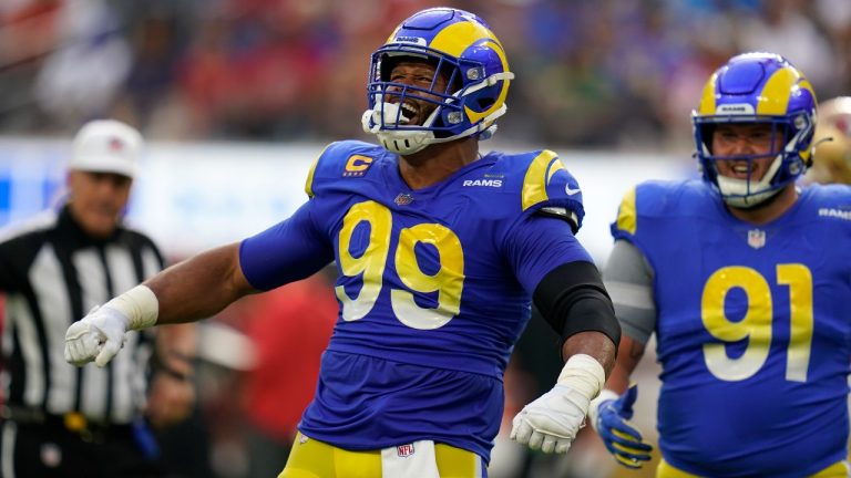 Los Angeles Rams defensive tackle Aaron Donald, left, celebrates after a sack as defensive tackle Greg Gaines watches during the first half of an NFL football game against the San Francisco 49ers Sunday, Oct. 30, 2022, in Inglewood, Calif. (Gregory Bull/AP Photo)