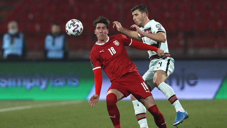 Serbia's Dusan Vlahovic, (left) and Portugal's Ruben Dias challenge for the ball during the World Cup group A qualifying soccer match at the Rajko Mitic stadium in Belgrade, Serbia, Saturday, March 27, 2021. (Darko Vojinovic/AP)