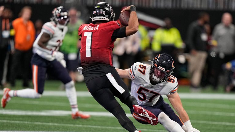 Atlanta Falcons quarterback Marcus Mariota (1) avoids a hit by Chicago Bears linebacker Jack Sanborn (57) during the first half of an NFL football game, Sunday, Nov. 20, 2022, in Atlanta. (Brynn Anderson/AP)