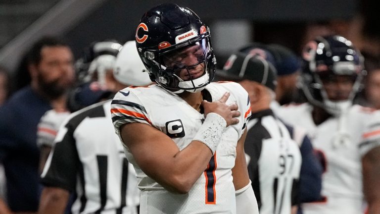 Chicago Bears quarterback Justin Fields holds his shoulder after an Atlanta Falcons tackle during the second half of an NFL football game, Sunday, Nov. 20, 2022, in Atlanta. (John Bazemore/AP Photo)