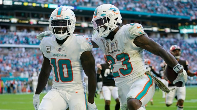 Miami Dolphins running back Jeff Wilson Jr. (23) is congratulated by wide receiver Tyreek Hill (10) after Wilson scores a touchdown during the second half of an NFL football game, Sunday, Nov. 13, 2022, in Miami Gardens, Fla. (AP Photo/Lynne Sladky)