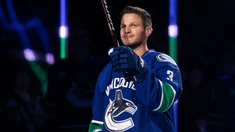 Former Vancouver Canucks player Kevin Bieksa is honoured prior to NHL hockey action between the Vancouver Canucks and the Anaheim Ducks in Vancouver on Thursday, November 3, 2022. Bieksa signed a one-day contract with the Canucks to officially retire. (Ben Nelms/CP)