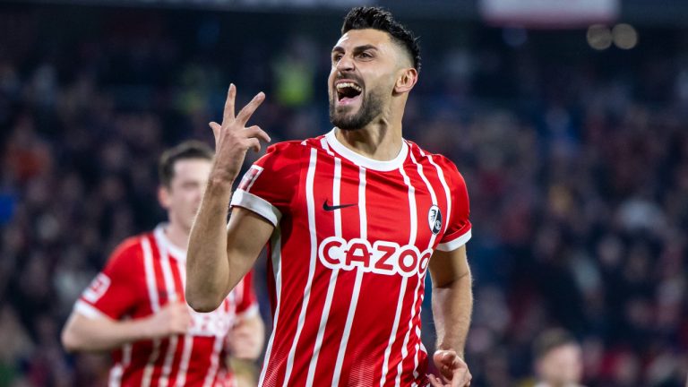 Freiburg's Vincenzo Grifo celebrates after scoring to 3-0 during the Bundesliga soccer match between Freiburg and FC Union Berlin at Europa-Park Stadion in Freiburg im Breisgau, Germany, Sunday, Nov. 13, 2022. . (Tom Weller/dpa via AP)