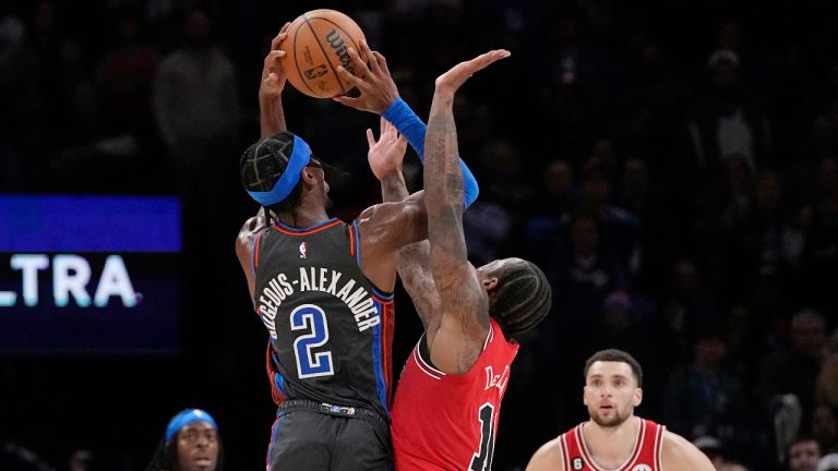 Oklahoma City Thunder guard Shai Gilgeous-Alexander (2) is fouled by Chicago Bulls forward DeMar DeRozan (11) as he shoots in overtime of an NBA basketball game Friday, Nov. 25, 2022, in Oklahoma City. Bulls' Zach LaVine, right, looks on. (Sue Ogrocki/AP)