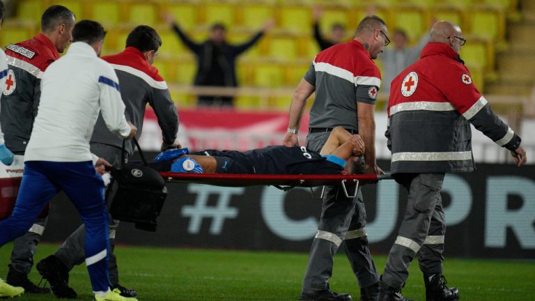 Medical staff carry Marseille's Amine Harit out to the pitch during the French League One soccer match between Monaco and Marseille at the Stade Louis II in Monaco, Sunday, Nov. 13, 2022. (Daniel Cole/AP)