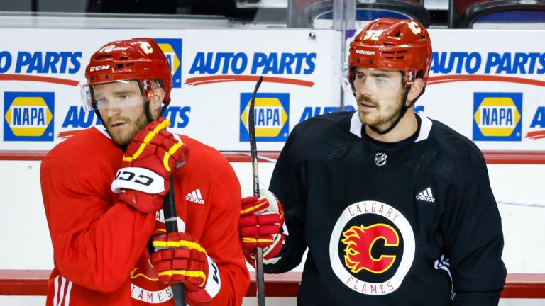 Calgary Flames, left to right, forward Jonathan Huberdeau, defenceman Mackenzie Weegar, defenceman Christopher Tanev, look on during a training camp practice in Calgary, Alta., Thursday, Sept. 22, 2022. (Jeff McIntosh/CP)