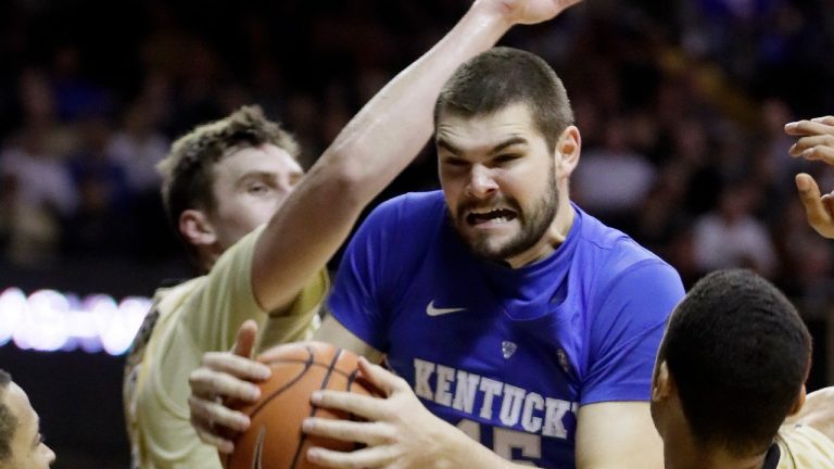 Kentucky forward Isaac Humphries, center, grabs a rebound in front of Vanderbilt's Luke Kornet, second from left, and Jeff Roberson (11) during the first half of an NCAA college basketball game on Jan. 10, 2017, in Nashville, Tenn. Melbourne United starting center Isaac Humphries has announced that he is gay and said he hopes his decision to publicly announce his sexuality will lead to more professional sportsmen doing the same. (Mark Humphrey/AP)