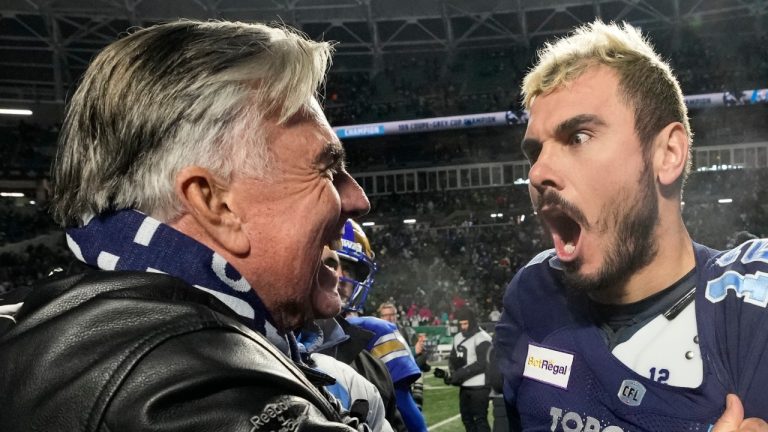 Toronto Argonauts quarterback Chad Kelly (12) celebrates with senior advisor Jim Barker after defeating the Winnipeg Blue Bombers in the 109th Grey Cup at Mosaic Stadium in Regina, Sunday, Nov. 20, 2022. (Frank Gunn/THE CANADIAN PRESS)