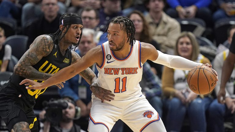 Utah Jazz guard Jordan Clarkson, left, guards New York Knicks guard Jalen Brunson during the second half of an NBA basketball game Tuesday, Nov. 15, 2022, in Salt Lake City. (Rick Bowmer/AP)