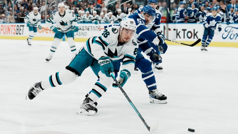 San Jose Sharks' Timo Meier brings the puck past Toronto Maple Leafs' Mark Giordano during first period NHL hockey action in Toronto. (Chris Young/CP)