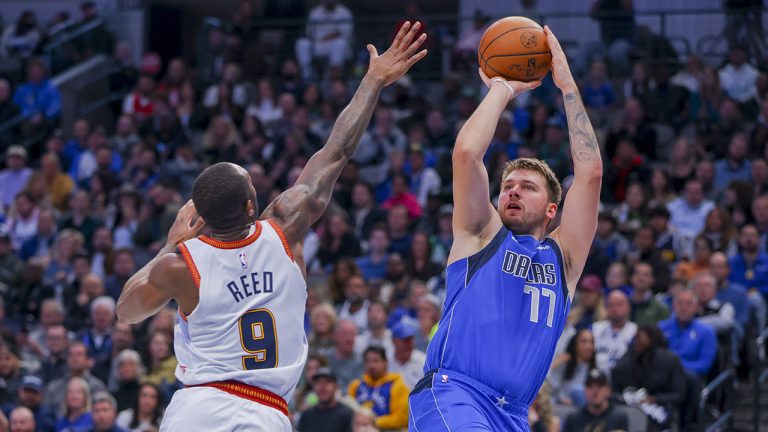 Dallas Mavericks point guard Luka Doncic (77) shoots over Denver Nuggets guard Davon Reed (9) during the second half of an NBA basketball game, Friday, Nov. 18, 2022, in Dallas. (Gareth Patterson/AP)