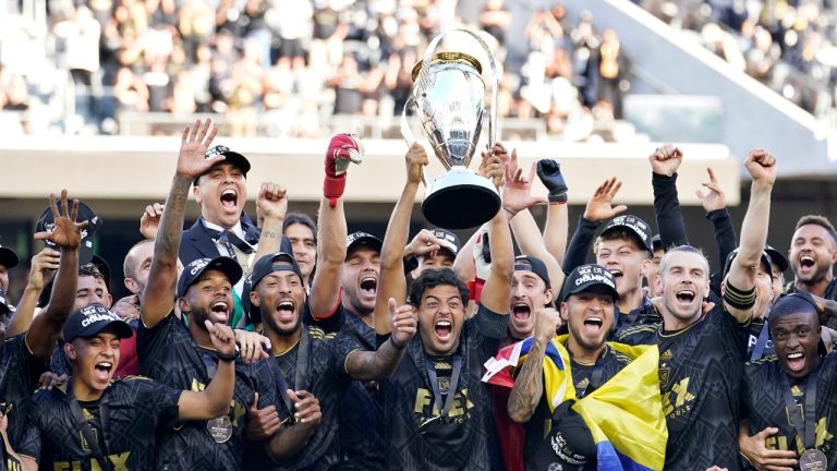 Los Angeles FC players celebrate with the trophy after defeating the Philadelphia Union in a penalty kick shootout to win the MLS Cup soccer match Saturday, Nov. 5, 2022, in Los Angeles. (Marcio Jose Sanchez/AP Photo)