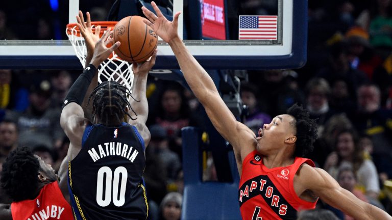 Toronto Raptors forward Scottie Barnes (4) attempts to block a shot by Indiana Pacers guard Bennedict Mathurin (00) during the second quarter of an NBA basketball game, Saturday, Nov. 12, 2022, in Indianapolis, Ind. (AP Photo/Marc Lebryk)