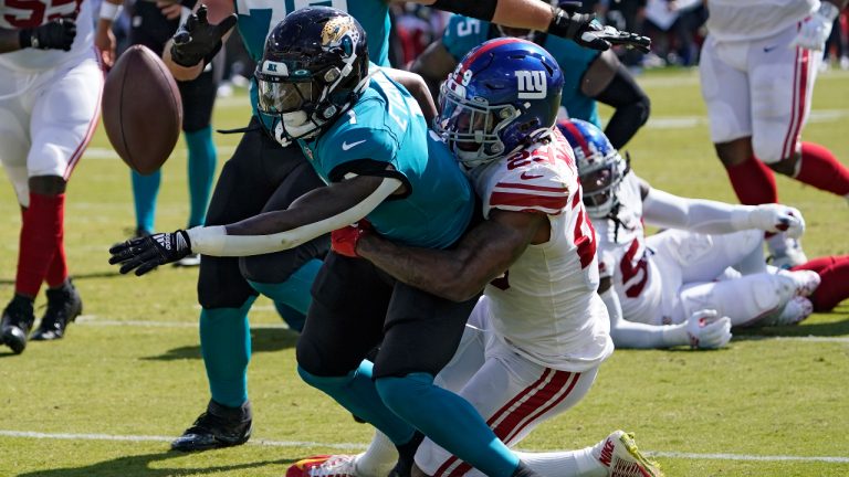 Jacksonville Jaguars running back Travis Etienne Jr. (1) fumbles when he gets hit by New York Giants safety Xavier McKinney (29) during the first half of an NFL football game Sunday, Oct. 23, 2022, in Jacksonville, Fla. (John Raoux/AP)