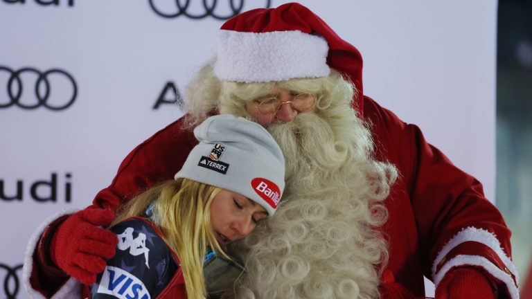 United States' Mikaela Shiffrin embraces Santa Claus after winning an alpine ski, women's World Cup slalom, in Levi, Finland, Sunday, Nov. 20, 2022. (Alessandro Trovati/AP)