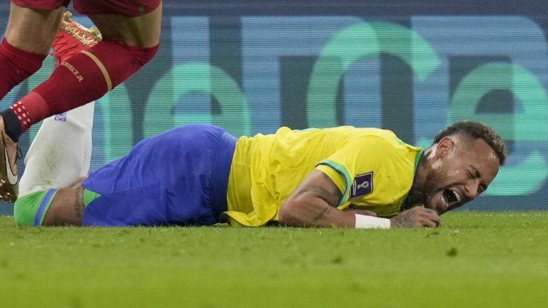 Brazil's Neymar grimaces as he falls to the ground during the World Cup group G soccer match between Brazil and Serbia, at the Lusail Stadium in Lusail, Qatar, Thursday, Nov. 24, 2022. (Andre Penner/AP)