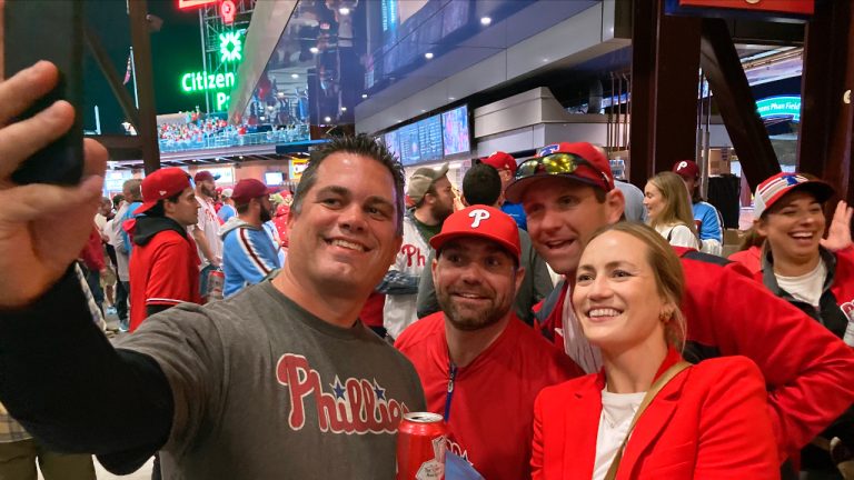 Jayme Hoskins, right, wife of Philadelphia Phillies first baseman Rhys Hoskins, poses with fans at Game 4 of the baseball World Series between the Phillies and the Houston Astros on Wednesday. Nov. 2, 2022, in Philadelphia. Hoskins tweeted she would buy fans beer before the game at Section 104 of the stadium. She paid for about 100 beers. (Daniel Gelston/AP)