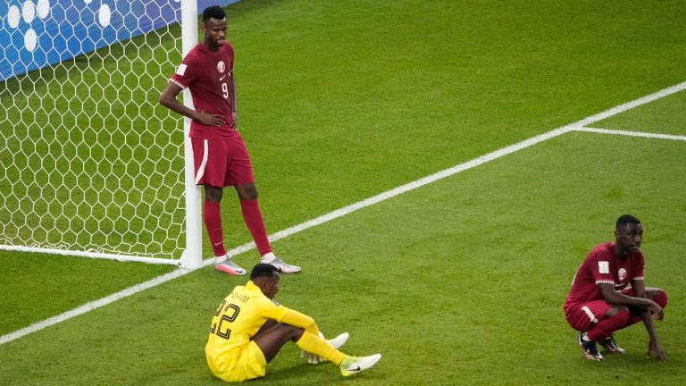 FILE - Qatar's Mohammed Muntari, left, and Qatar's goalkeeper Meshaal Barsham look on after the World Cup group A soccer match between Qatar and Senegal, at the Al Thumama Stadium in Doha, Qatar, Friday, Nov. 25, 2022. Senegal won 3-1. Qatar became the first host nation in World Cup history to lose the opening match, and then only the second host to be eliminated from the group stage. South Africa in 2010 was the first host nation to be eliminated in group stage but still had a chance to advance in its third and final group match. (Ariel Schalit/AP, File)