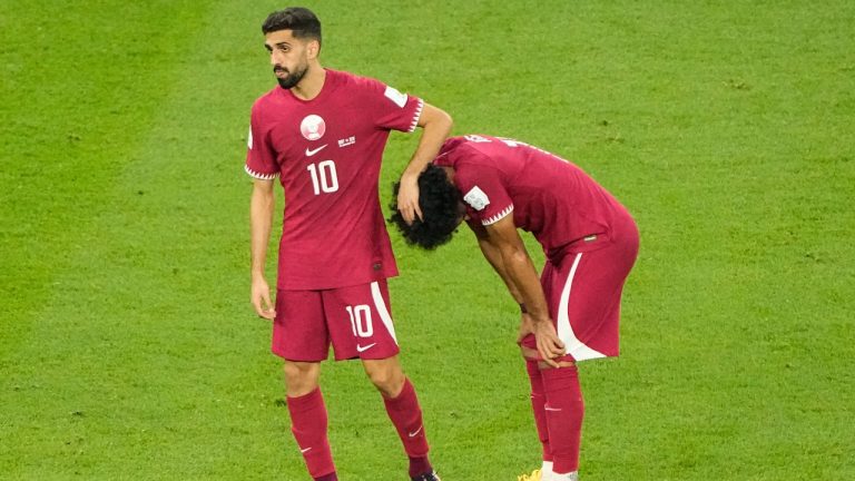 Qatar's Hassan Al-Haydos, left, and Akram Afif reacts after the World Cup match between Qatar and Senegal, at the Al Thumama Stadium in Doha, Qatar, Friday, Nov. 25, 2022. Qatar would officially be eliminated from the tournament after Netherlands and Ecuador ended in a draw (Ariel Schalit/AP Photo)