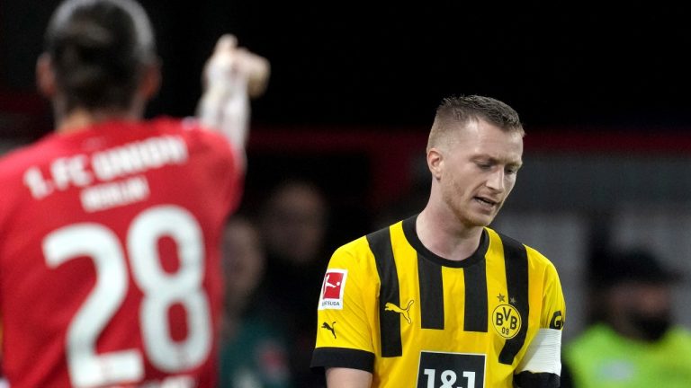 Dortmund's Marco Reus, right, reacts as Union's Christopher Trimmel, left points up during the German Bundesliga soccer match between 1. FC Union Berlin and Borussia Dortmund in Berlin, Germany, Sunday, Oct. 16, 2022. Reus suffered an ankle injury against Schalke in September and has struggled to recover from it (Michael Sohn/AP Photo)