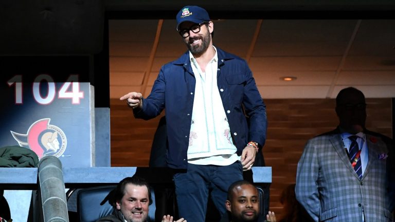 Actor Ryan Reynolds gestures towards a fan as he is recognized during a break in the play as the Ottawa Senators take on the Vancouver Canucks in Ottawa, on Tuesday, Nov. 8, 2022. Reynolds is rumoured to be interested in buying the Senators franchise. (Justin Tang/The Canadian Press)