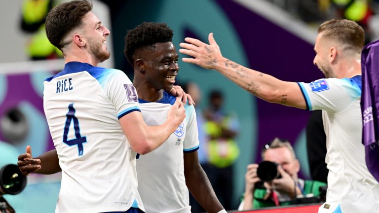 England's #17 Bukayo Saka celebrates with teammates Declan Rice and Luke Shaw after scoring 2-0 during the FIFA World Cup Group B football match in Qatar between England and Iran at the Khalifa International Stadium on November 21, 2022. (Jonas Ekströmer/TT)