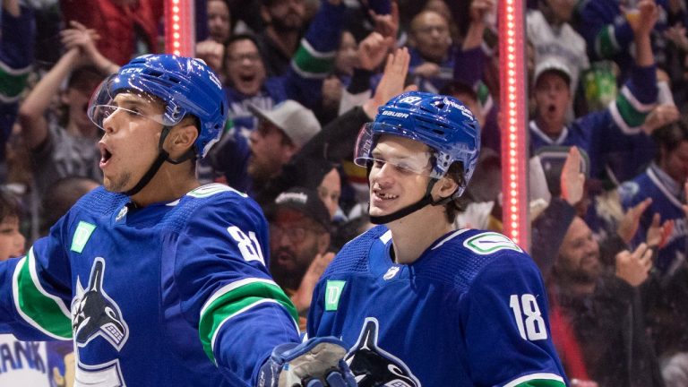 Jack Studnicka, right, celebrates Dakota Joshua's, 81, goal against the Anaheim Ducks during the third period of a game in Vancouver on Thursday, November 3, 2022. (Ben Nelms/The Canadian Press)